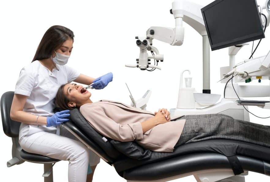 a dentist working on a patient in a dentist chair